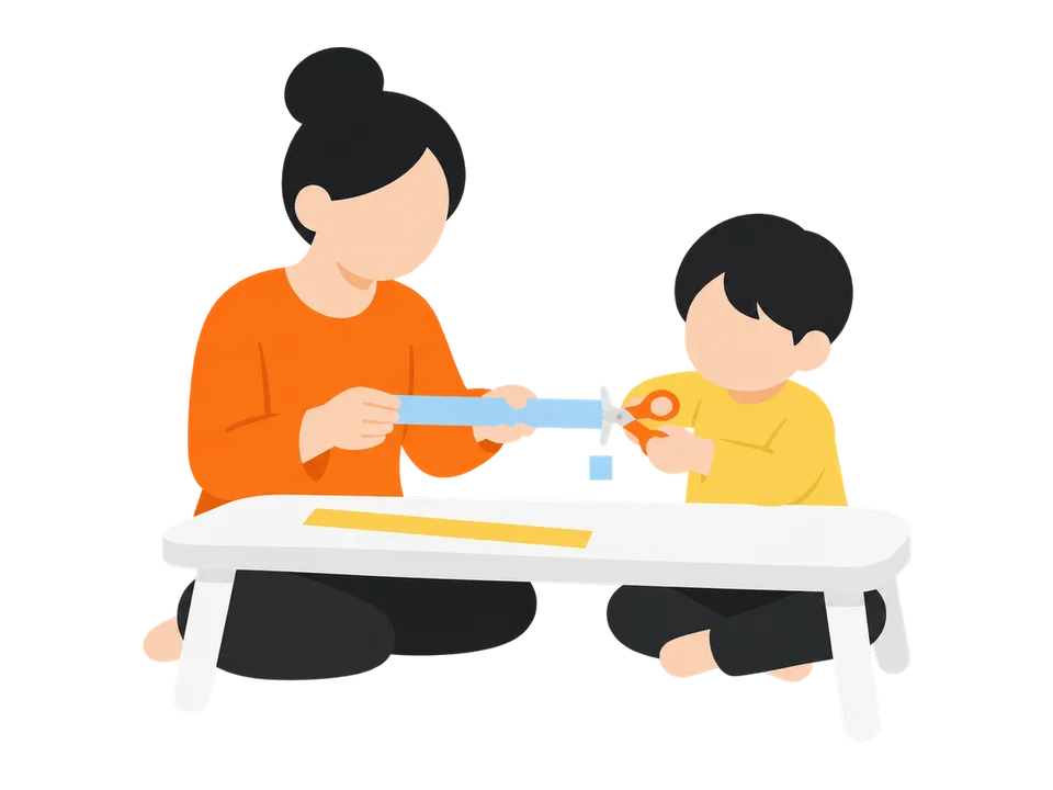 2. 大人が細長い紙の端を持ち、子どもが1回で切ります。